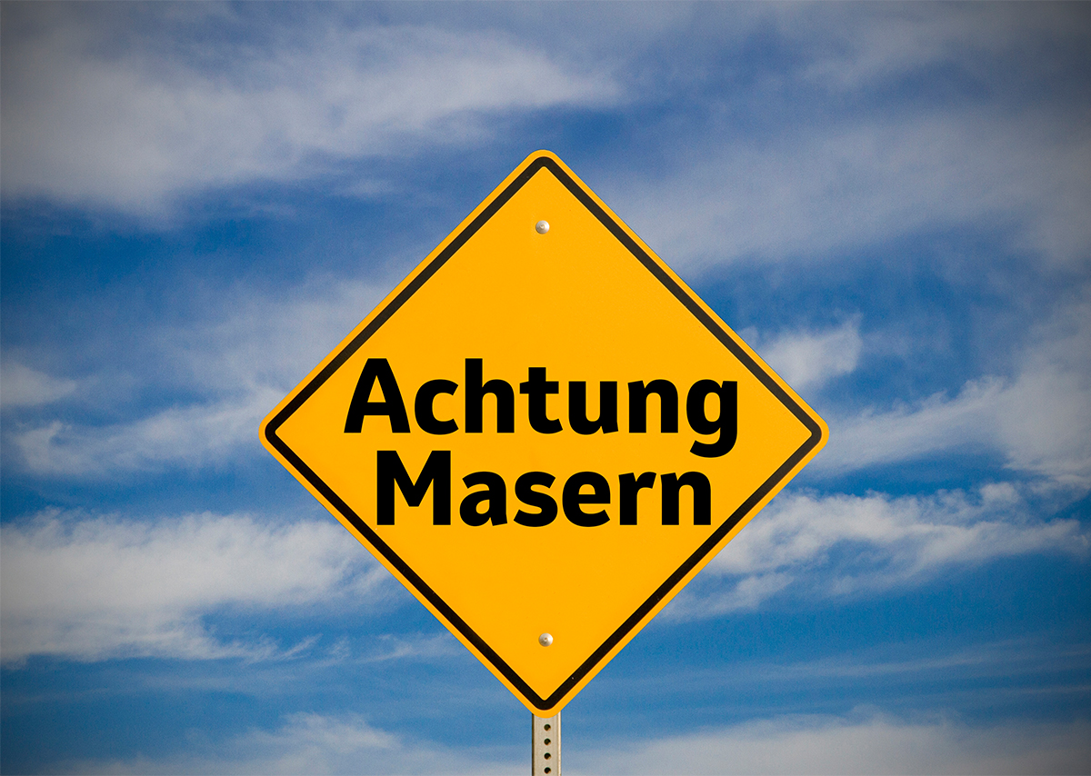 Gelbes Warnschild, mit der Aufschrift „Achtung Masern“.